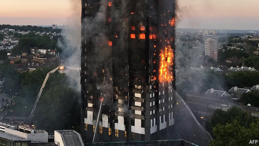 A high-rise building engulfed in flames and smoke, with firefighters using a ladder to spray water on the blaze.